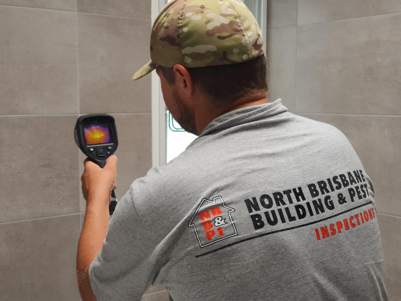 Brett is in the shower using the thermal imaging cameras to detect moisture